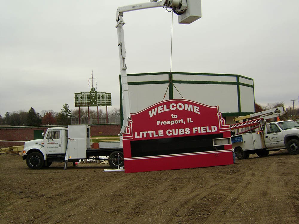 Little Cubs Field Sign being hung. 